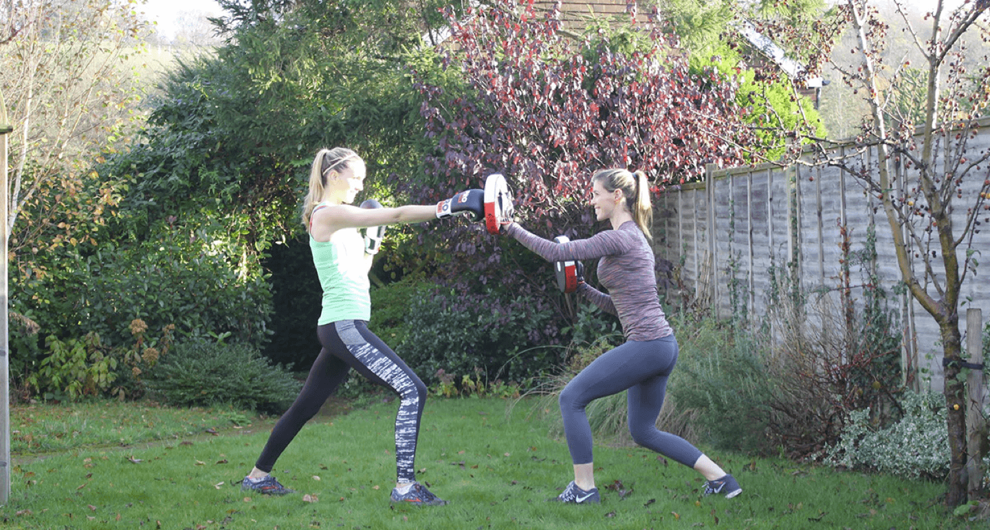 Lucinda & Client Performing Pad Workout